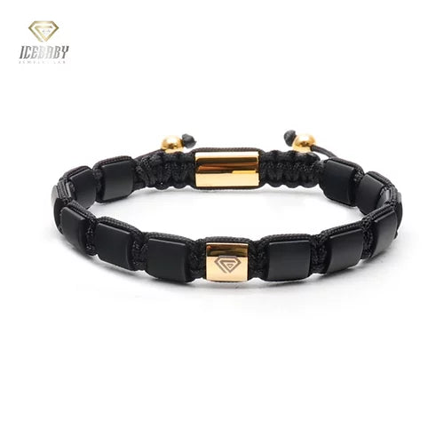 BRACELET  WITH BLACK ONYX AND GOLD CHARM.